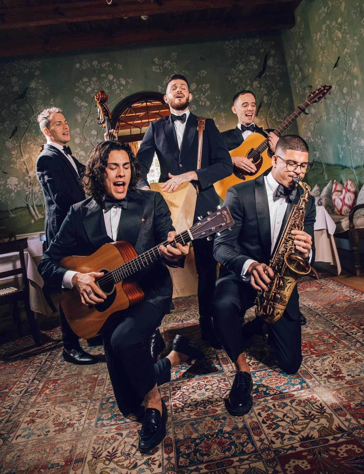Five Empire musicians performing together in black tie at a wedding